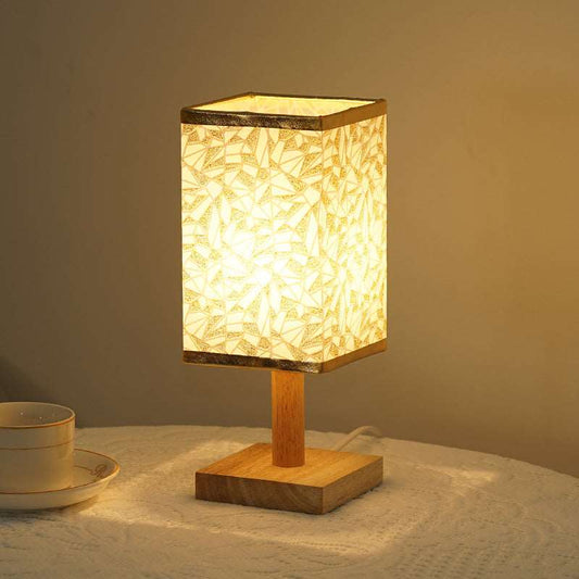 Natural bamboo and wood base plate detail on a modern table lamp