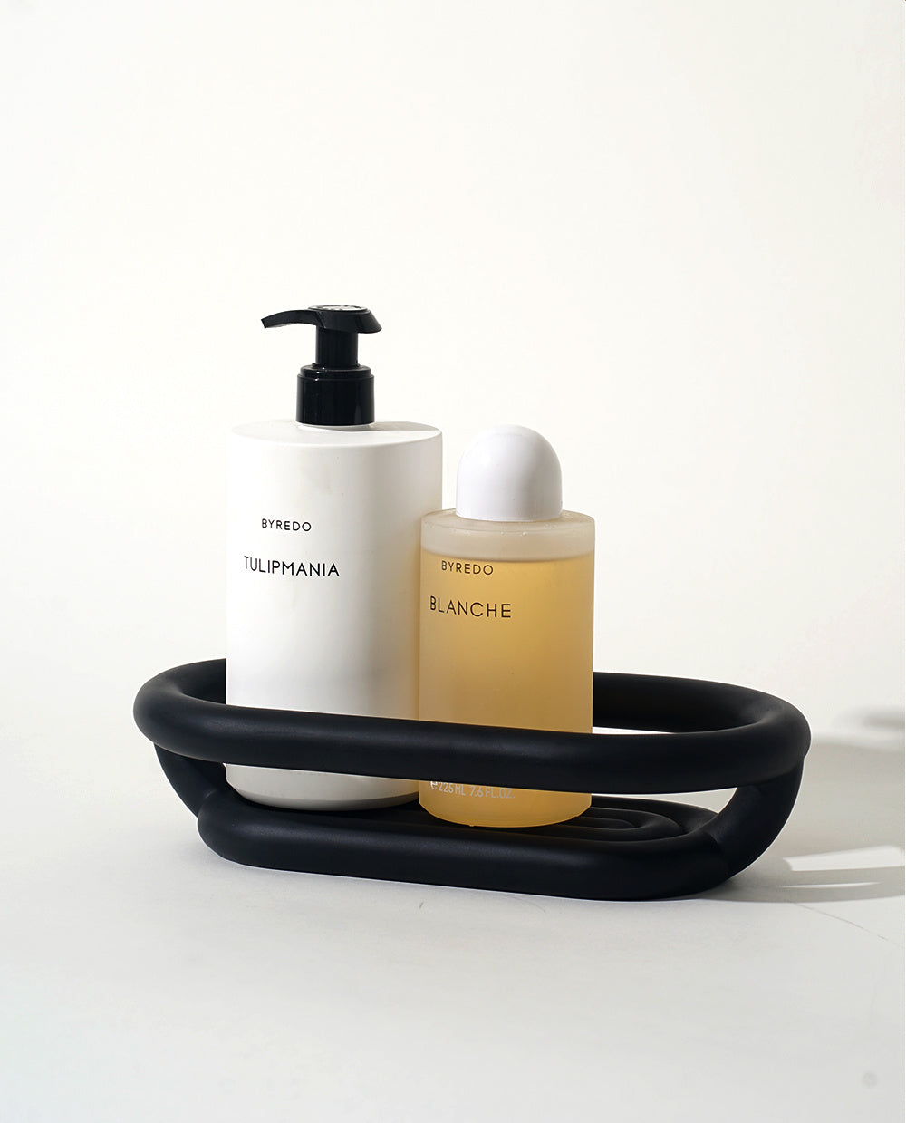 Close-up of the matching matte black resin finish on both the soap dish and storage tray