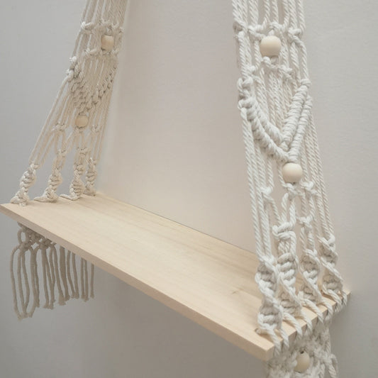 Close-up of the natural white check pattern woven into the bohemian cotton tapestry shelf