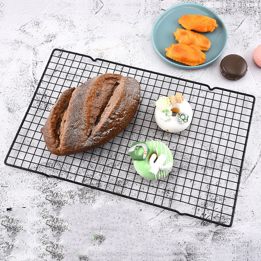 Cake cooling rack with fresh baked bread and donuts on top