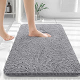 Silver gray chenille floor mat beside a bed used as a soft bedroom pedal mat