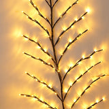Christmas branch tree lamp glowing with warm LED lights for indoor bedroom decor