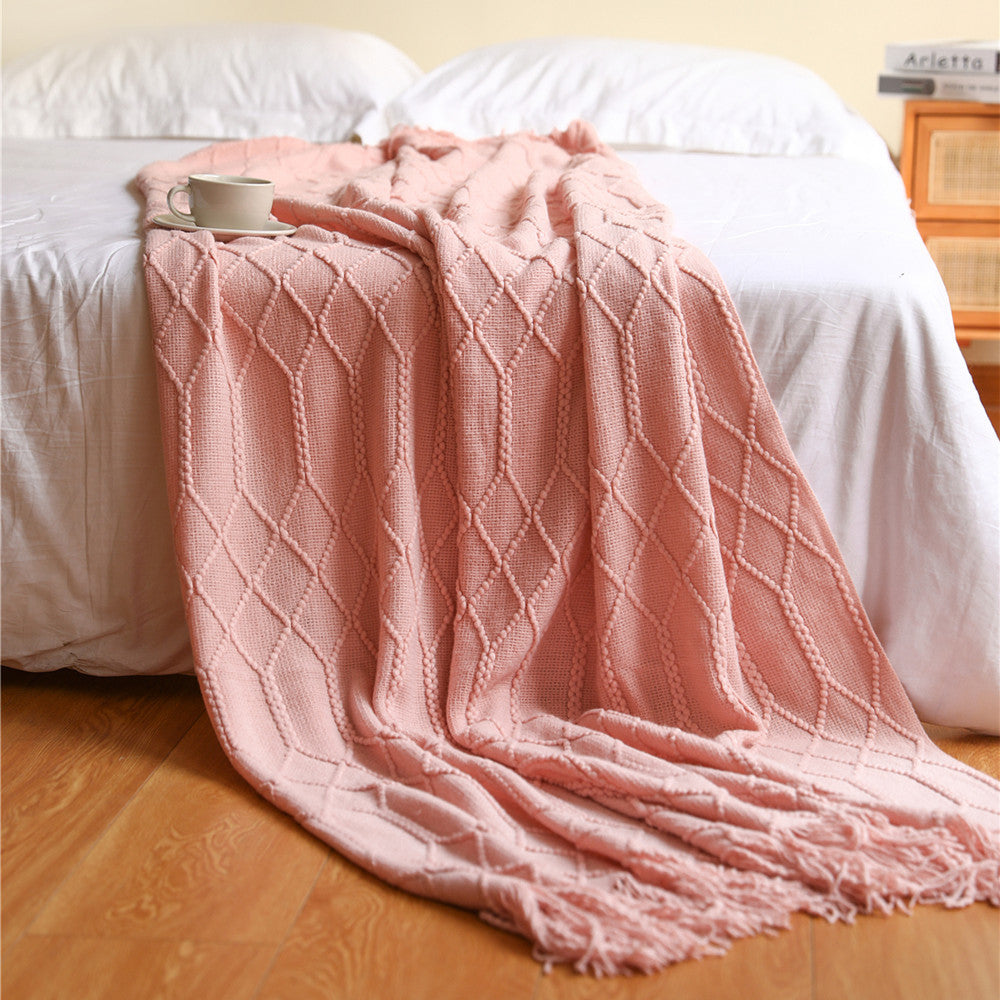Large size 51x79 inch coral fleece throw blanket layered across a full bed at the foot