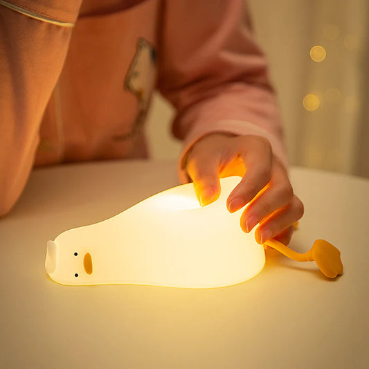 Child holding flat duck silicone night lamp showing size
