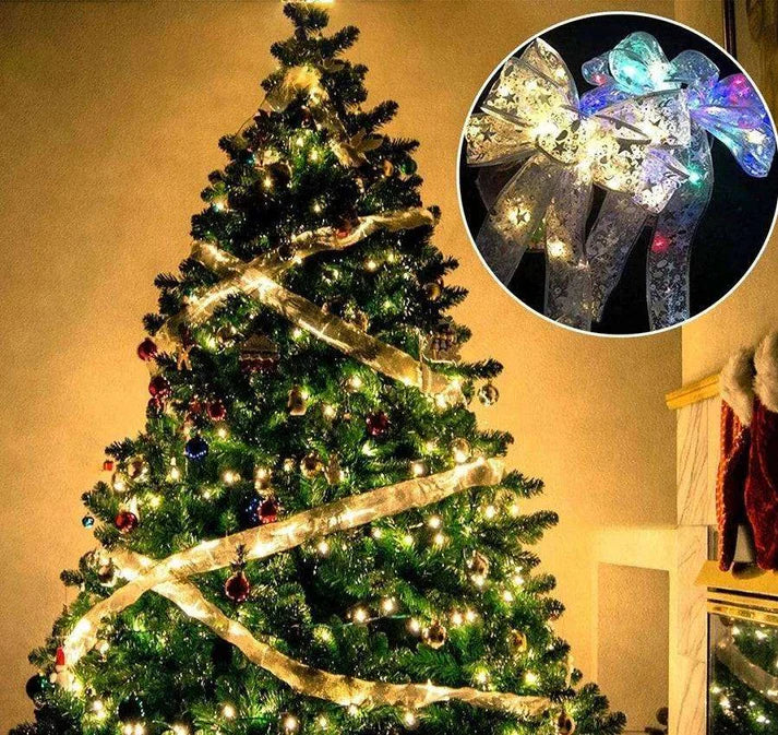 Lighted ribbon bow used as Christmas tree decoration