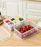 White plastic refrigerator vegetable storage container with compartments plain background