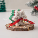Handmade snowflake candle with red ribbon bow