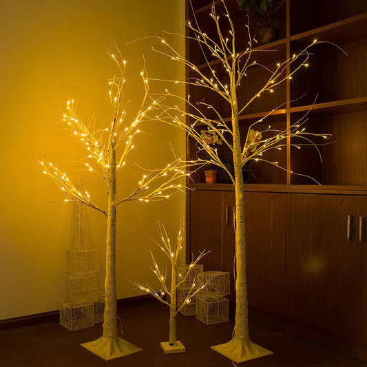 LED birch tree lights glowing warmly in living room corner