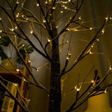 Warm ambient glow from LED birch tree lights at night