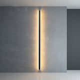 Minimalist LED wall lamp glowing in dark room