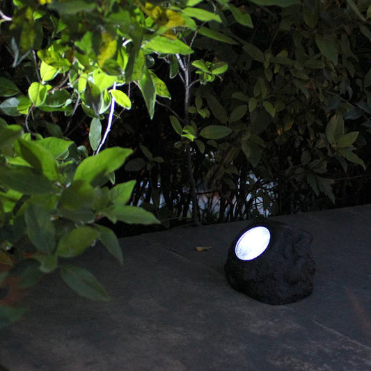 Solar rock garden light glowing white LED at night