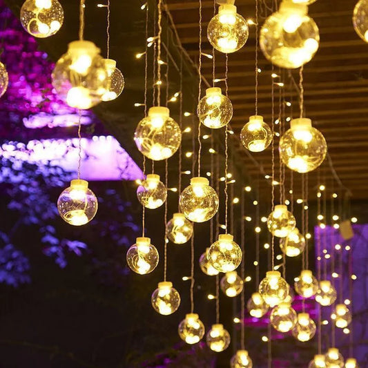 Splendas LED curtain string lights with warm white orbs in bedroom decor setting