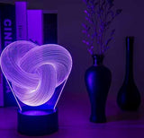 Remote control and touch base of the twist abstract 3D LED night light on a desk