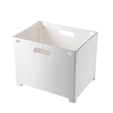 Bathroom floor completely clear with clothes stored in a white wall mounted hamper above
