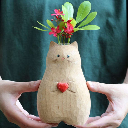 Side view of handmade wooden cat vase with heart accent