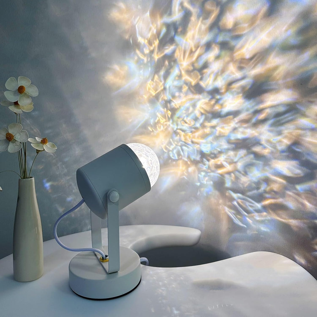 White lamp on a table with a vase of flowers and a blurred abstract background