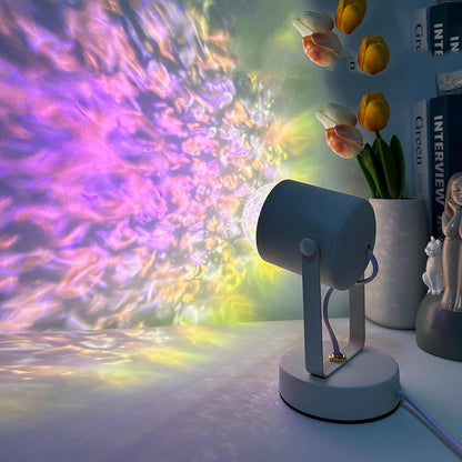 Colorful light projector on a table with flowers and books in the background