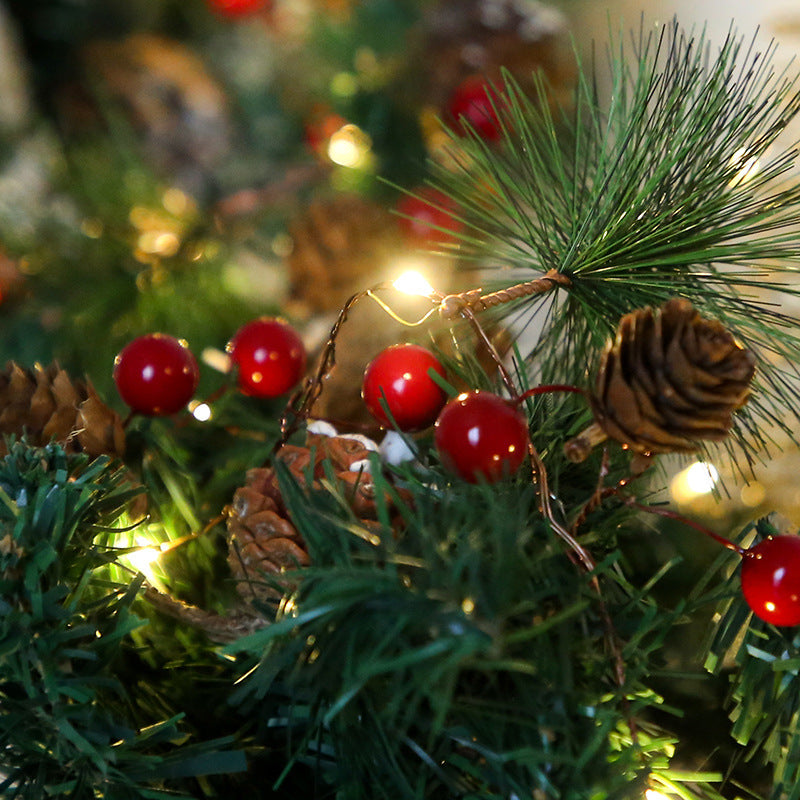 Copper wire pine cone string lights glowing on holiday table