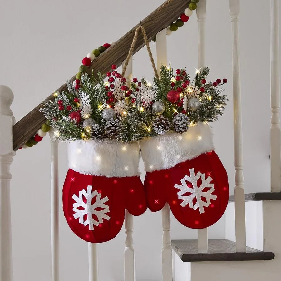 LED mitten wreath with snowflake designs hanging on a staircase.