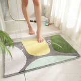 Water being absorbed quickly into the surface of the non slip absorbent bathroom floor mat