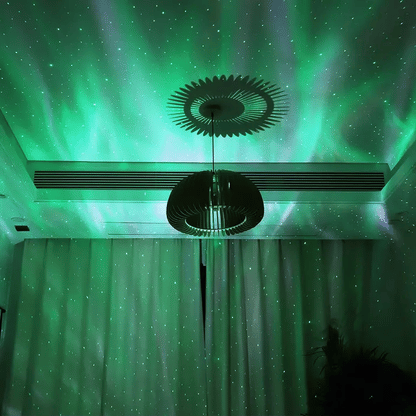 Aurora projector lamp projecting pink northern lights on ceiling