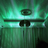Aurora projector lamp projecting pink northern lights on ceiling