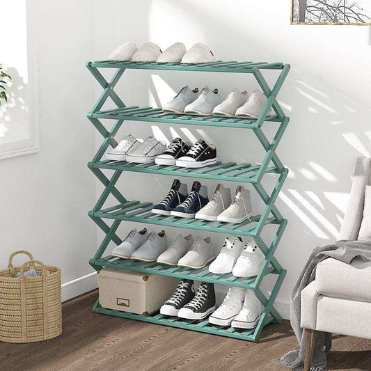 Green 4-tier foldable bamboo plant stand with shoes in living room
