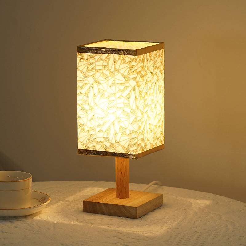 Natural bamboo and wood base plate detail on a modern table lamp