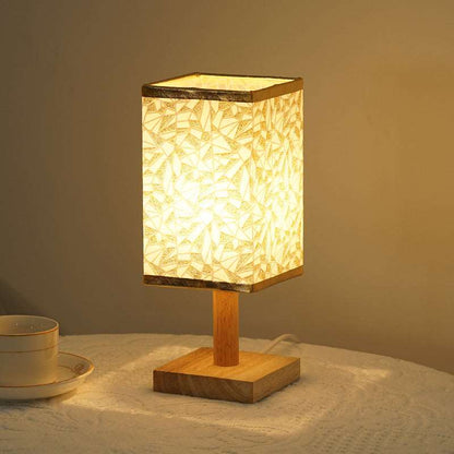 Natural bamboo and wood base plate detail on a modern table lamp