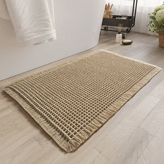 Microfiber absorbent bathroom bath mat in minimalist brown waffle design on floor