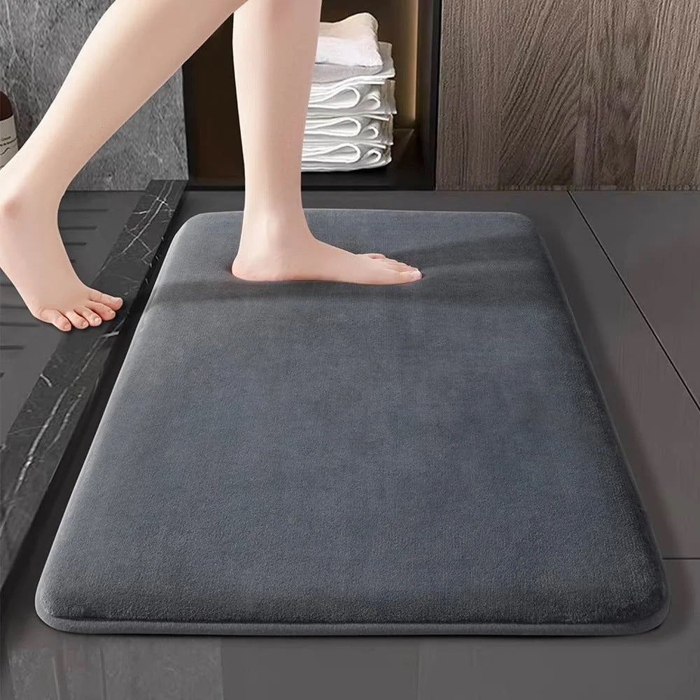 Large 80x120cm flannel bathroom mat covering the full area in front of a wide shower door
