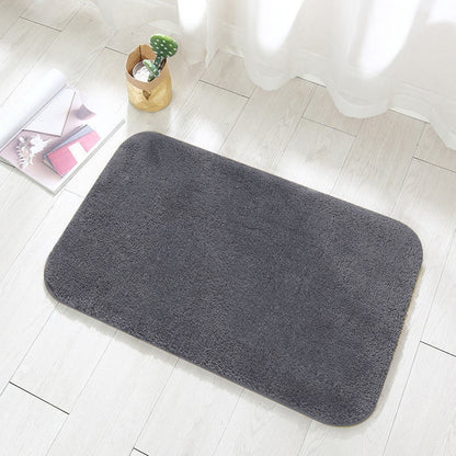 Brown absorbent flannel bathroom mat in a modern bathroom with dark wood vanity
