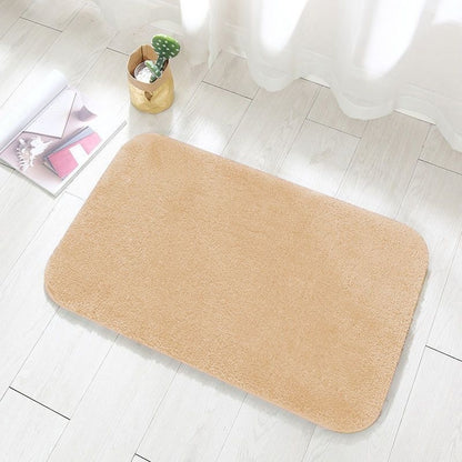 Camel colored flannel floor mat at the entrance of a bedroom beside a bed
