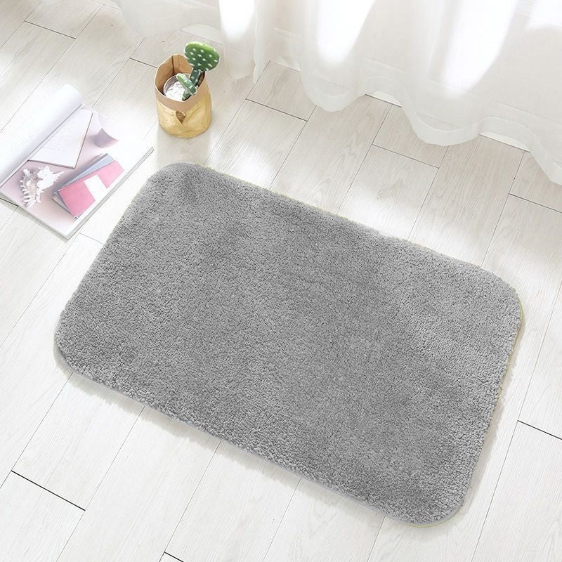Flannel bathroom mat shown drying quickly after absorbing water from wet feet
