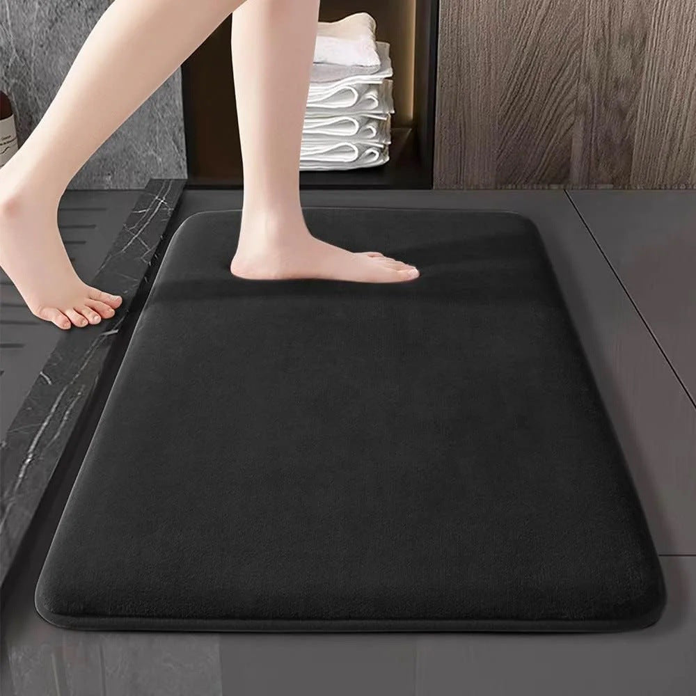 Wine red flannel bathroom mat outside a bathtub on a modern bathroom floor
