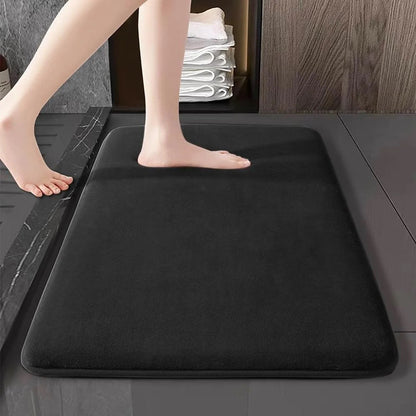Wine red flannel bathroom mat outside a bathtub on a modern bathroom floor
