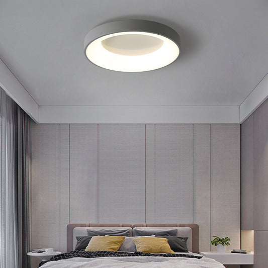 Modern minimalist flush mount bedroom ceiling lamp installed in a white master bedroom
