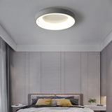 Modern minimalist flush mount bedroom ceiling lamp installed in a white master bedroom