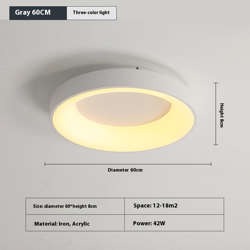 Flush mount bedroom ceiling lamp used in a small lounge room providing soft overhead light
