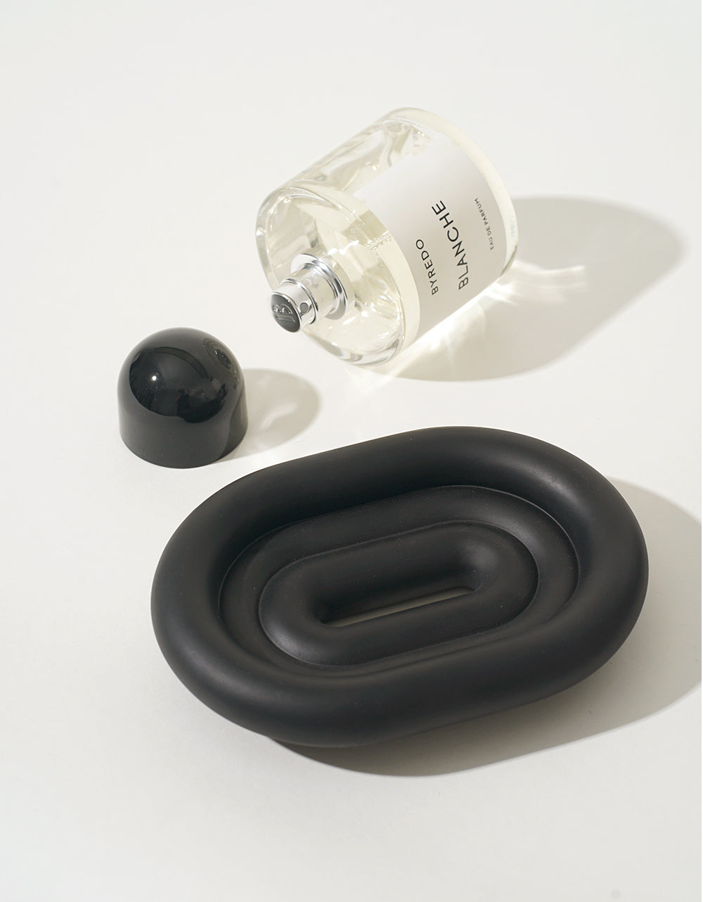 Close-up of the raised drainage surface on the matte black resin soap dish
