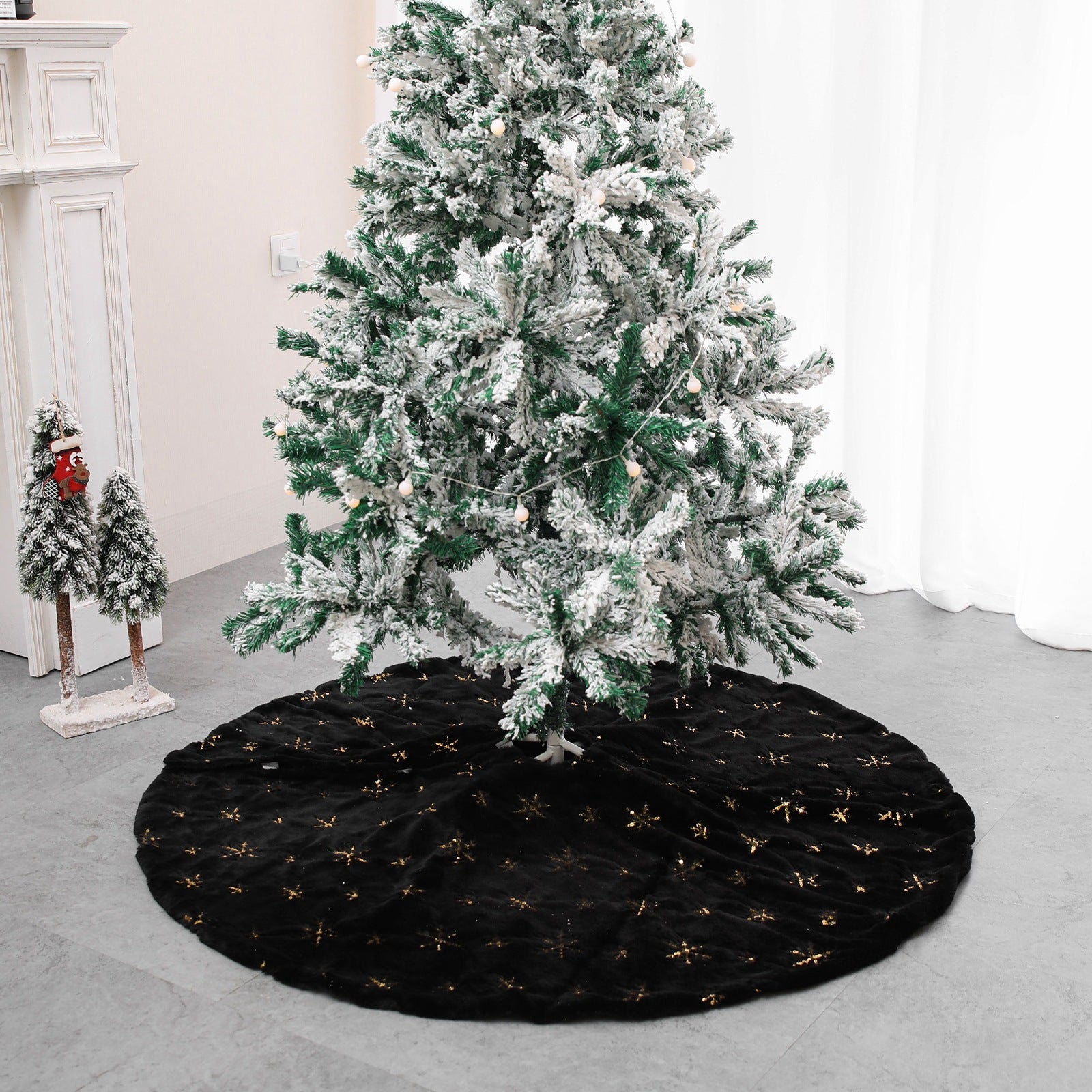 Black velvet Christmas tree skirt with gold snowflake embroidery flat lay