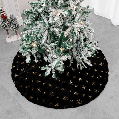 Black velvet Christmas tree skirt placed under decorated holiday tree