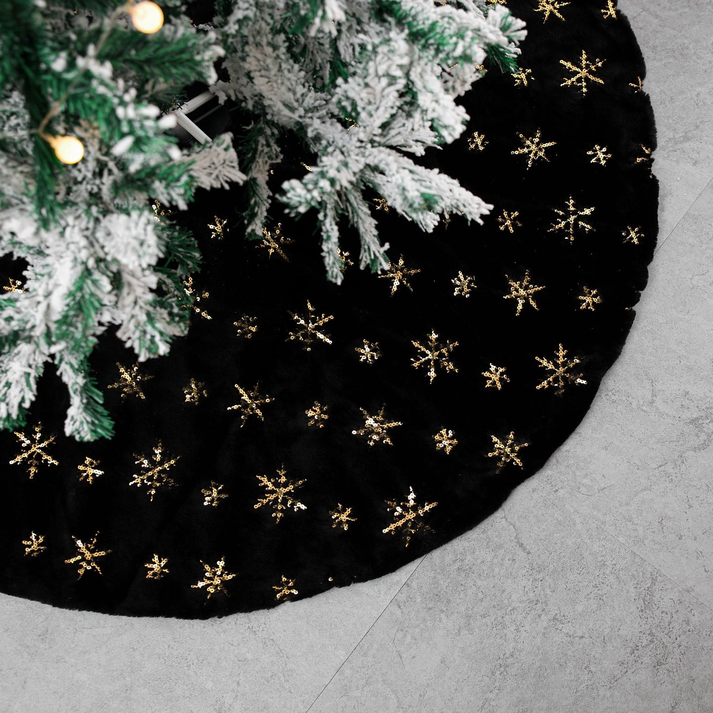 Close up texture detail of black velvet Christmas tree skirt gold embroidery