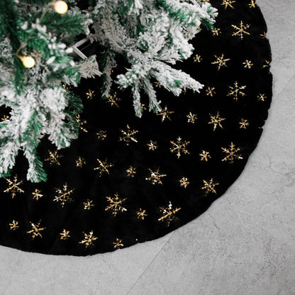 Close up texture detail of black velvet Christmas tree skirt gold embroidery