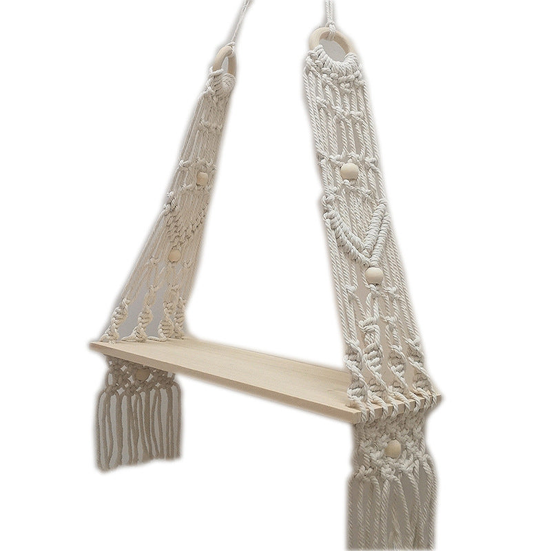 Bohemian cotton wall tapestry shelf in natural white hanging on a bedroom wall