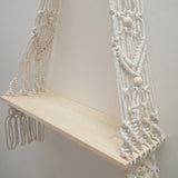 Close-up of the natural white check pattern woven into the bohemian cotton tapestry shelf