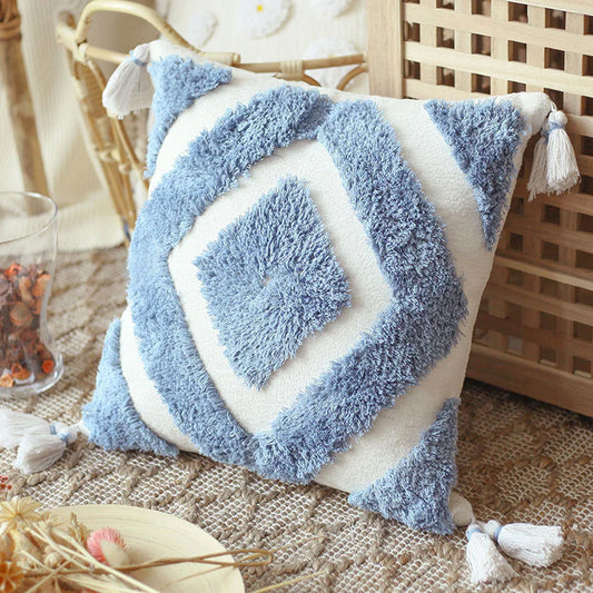 Blue boho tufted pillow cover with tassels on chair