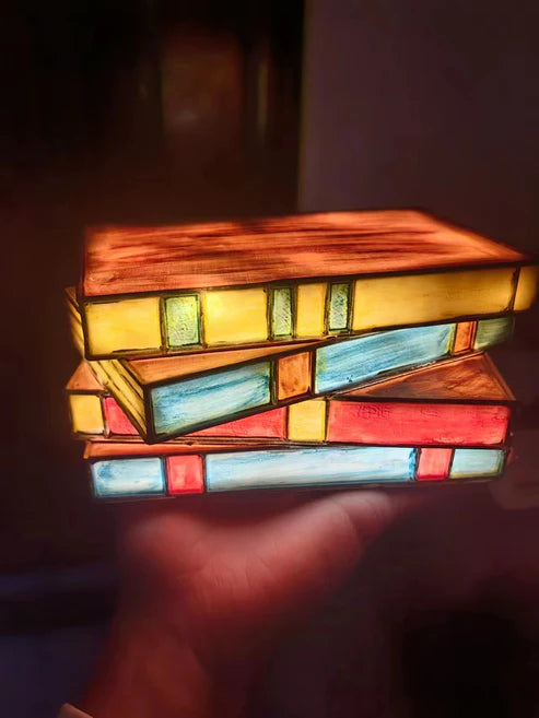 Close up of book stack lamp showing page detail and glow