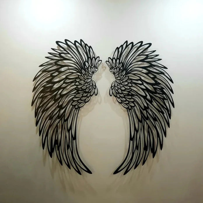 Close up of carved metal angel wings feather detail iron wall decor
