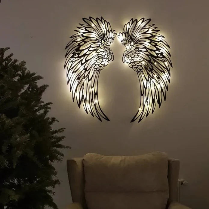 Carved metal angel wings wall decor with LED light in dark room